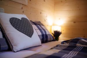 a bed with a pillow with a heart on it at Penzion Šterk in Most na Soči