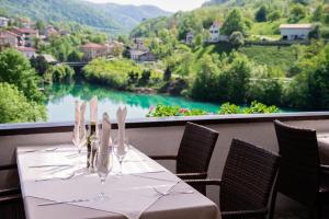 a table with a view of a river and mountains at Penzion Šterk in Most na Soči