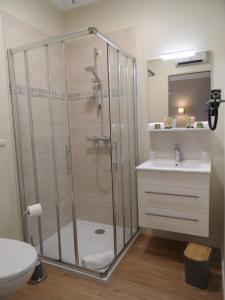 a bathroom with a shower and a toilet and a sink at L'Escale in Sainte-Marie-de-Ré