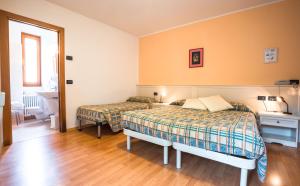 Voodi või voodid majutusasutuse Albergo Maggiorina toas