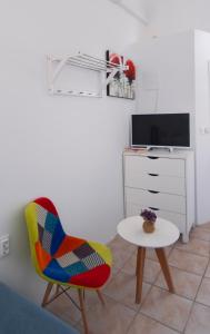 a chair and a table in a room at Apartments Mia in Dubrovnik