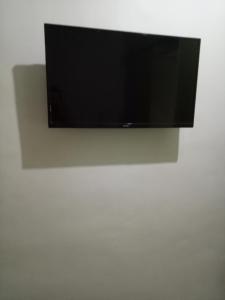 a flat screen tv hanging on a white wall at Vimelzu Mhavic guest room in Manila