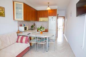 a kitchen and living room with a couch and a table at Chara's Sea View House in Haraki +9 photos