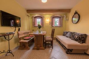 a living room with a couch and a table at Apartments Villa Sušanj in Matulji