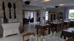 a restaurant with tables and chairs in a room at Le Mareuillais Hotel-Restaurant in Mareuil-sur-Lay