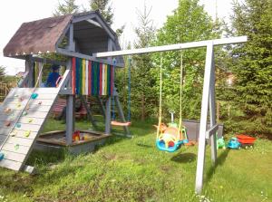 a playground with a slide and a play house at Cichy Zakątek in Sianozety
