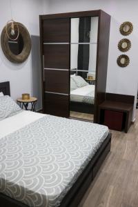 a bedroom with a bed and a large mirror at Zen Luxury Living in Thessaloniki