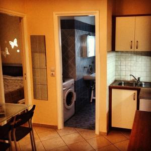 a kitchen with a sink and a washing machine at Sunday Apartments in Nafplio