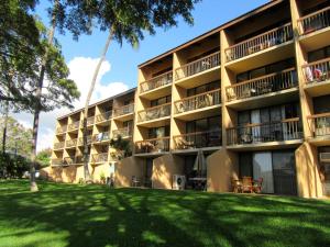 un edificio de apartamentos con césped delante en Maui-LICIOUS by the Beach, en Kihei