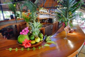 a bowl of fruit on a table in a bar at L'heure Bleue in Ambatoloaka