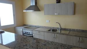 A kitchen or kitchenette at Apartamentos Cala Llonga