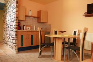 a kitchen with a table and a table and chairs at Ferienwohnung Götze in Irxleben
