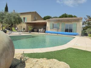 a swimming pool in front of a house at La Provence in Vaison-la-Romaine