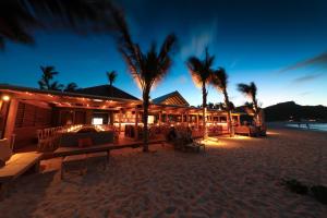 a restaurant on the beach at night at Pearl Beach Hotel in Saint-Jean