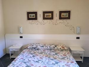 a bedroom with a bed with two nightstands at Hotel Danila in Portoferraio