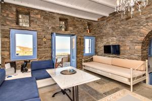 a living room with a stone wall at Villa Tina in Arnados