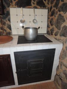 a pot on top of a stove in a kitchen at Rural House Etna in Castiglione di Sicilia