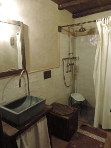 a bathroom with a sink and a shower at Rural House Etna in Castiglione di Sicilia