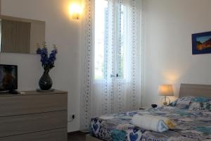 En eller flere senge i et værelse på Loft La Conchiglia