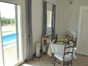 a dining room with a table and a mirror at La Provence in Vaison-la-Romaine