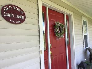 a red door on a house with a sign on it at Old Town Country Landing in Niagara-on-the-Lake