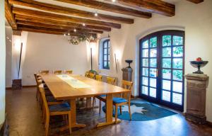 a dining room with a large wooden table and chairs at Landhotel Battenheimer Hof in Bodenheim