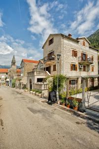 an old building on the side of a street at Hotel Admiral in Perast