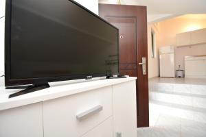 a flat screen tv sitting on top of a white cabinet at Apartmani Maća in Sikovo