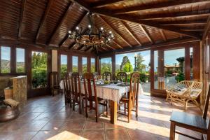 a dining room with a table and chairs and a chandelier at Casa da Encruzilhada in Ponte de Lima