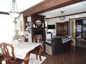 a dining room with a table and a couch at gite des iles in Matane