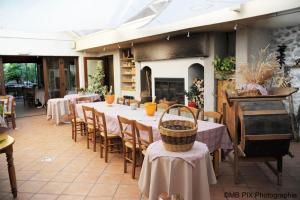 a restaurant with tables and chairs and a fireplace at Auberge d'Anthy in Anthy