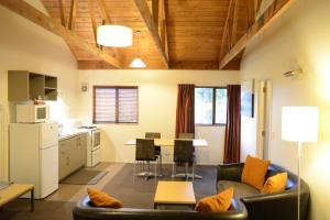 a living room with a couch and a table at The Hobbit Motorlodge in Ohakune