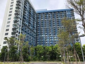 a tall building with trees in front of it at Blu Thew Talay Estate Hua Hin in Phetchaburi