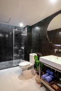 a bathroom with a toilet and a shower and a sink at AYA Homestay in Ho Chi Minh City +33 photos