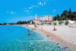 a group of people swimming in the water on a beach at house Paola in Tribalj