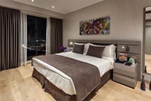 a bedroom with a large bed and a large window at Fraser Place Antasya Istanbul in Istanbul