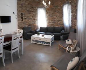 a living room with a couch and a table at Elia Sea Home in Agios Romanos