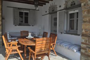 a dining room with a wooden table and chairs at Elia Sea Home in Agios Romanos