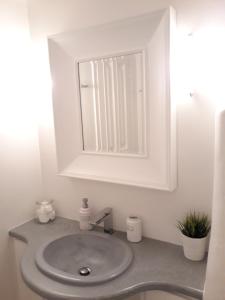 a white bathroom with a sink and a mirror at Elia Sea Home in Agios Romanos +27 photos