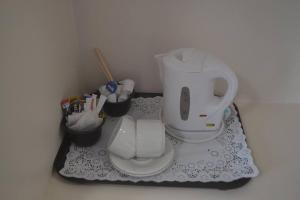 a bathroom with a white toilet and some containers at Teac Jack in Bunbeg