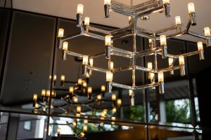 a chandelier with lights in front of a mirror at HOTEL M's EST KYOTO STATION SOUTH in Kyoto