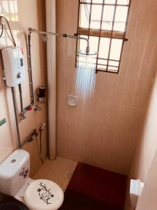 a small bathroom with a shower and a toilet at Suria Homestay JB with Private Pool in Johor Bahru