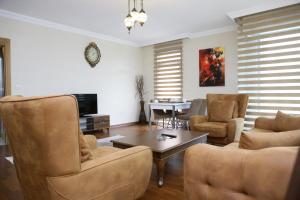 a living room with a couch and chairs and a table at ADEN APART in Ankara