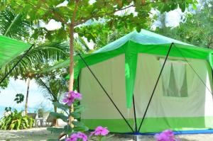a green and white tent on the beach at Koh Ngai Camping Restaurant @ Bar in Ko Ngai