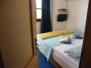 a bedroom with a bed with two towels on it at Apartment Mamut in Premantura