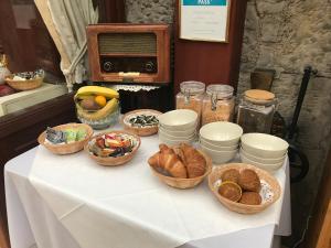 a table with baskets of food and bread on it at Clarke Cottage Guest House in Dunfermline