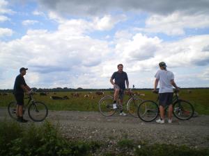 three people standing with their bikes on a dirt road at Ethno Village Stara Lonja in Lonja
