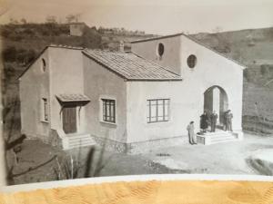 an old black and white photo of a house at La Palazzina in Chiusdino