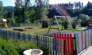 a fence in a park with a playground at Roden Dom Holiday Home in Apriltsi +14 photos