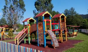a set of colorful playground equipment in a park at Roden Dom Holiday Home in Apriltsi